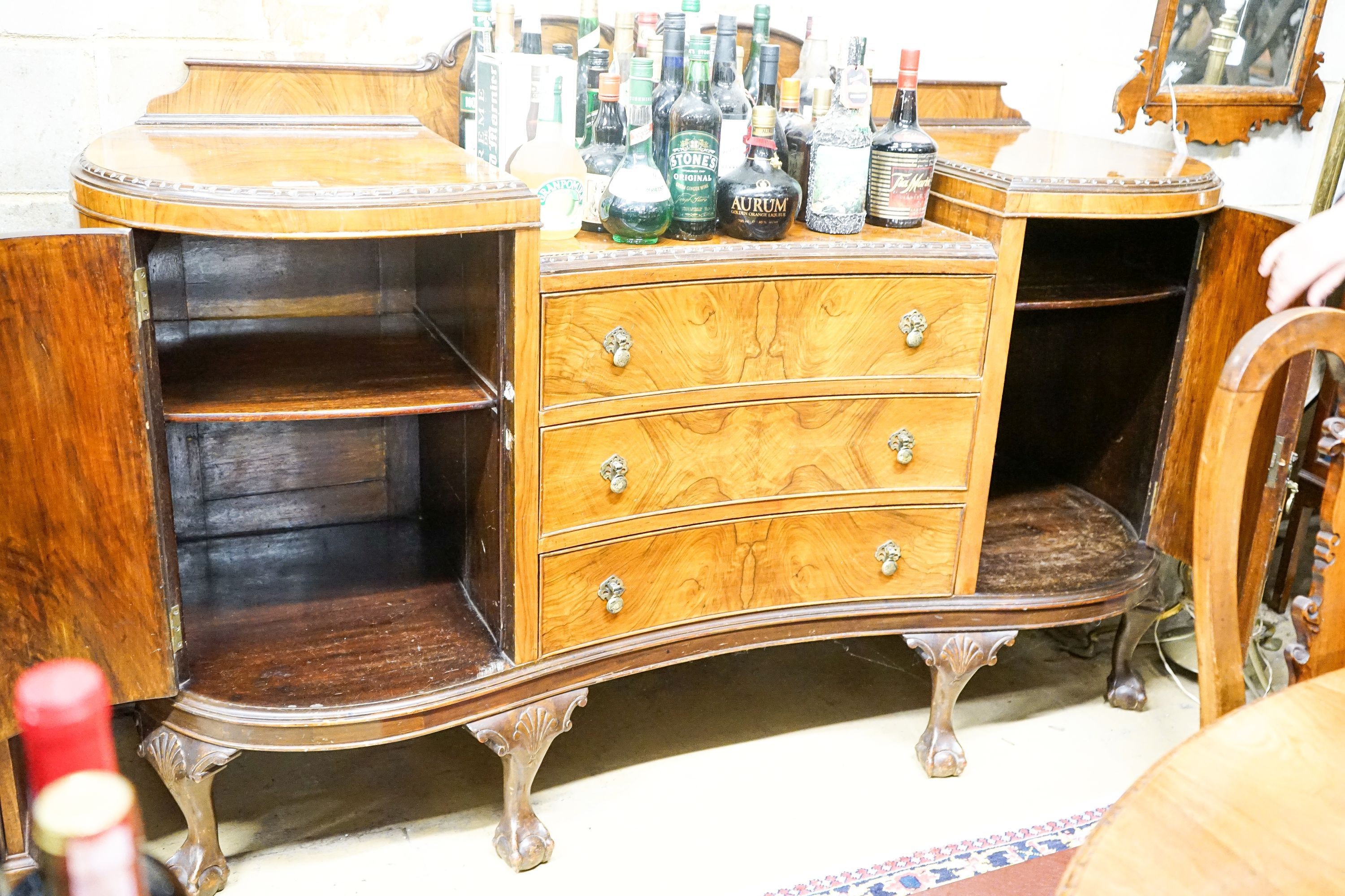 A Queen Anne style figured walnut dining suite comprising extending dining table, 200cm extended (one spare leaf), width 104cm, height 76cm, six chairs (two with arms) and a concave fronted sideboard